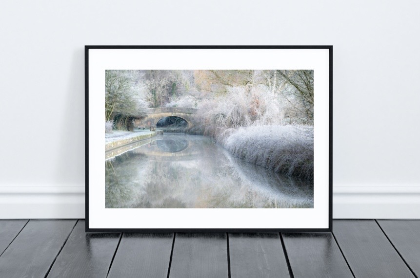 Framed art print in a modern living room setting